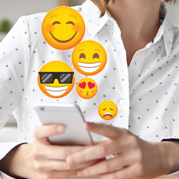 person using mobile phone to send emojis